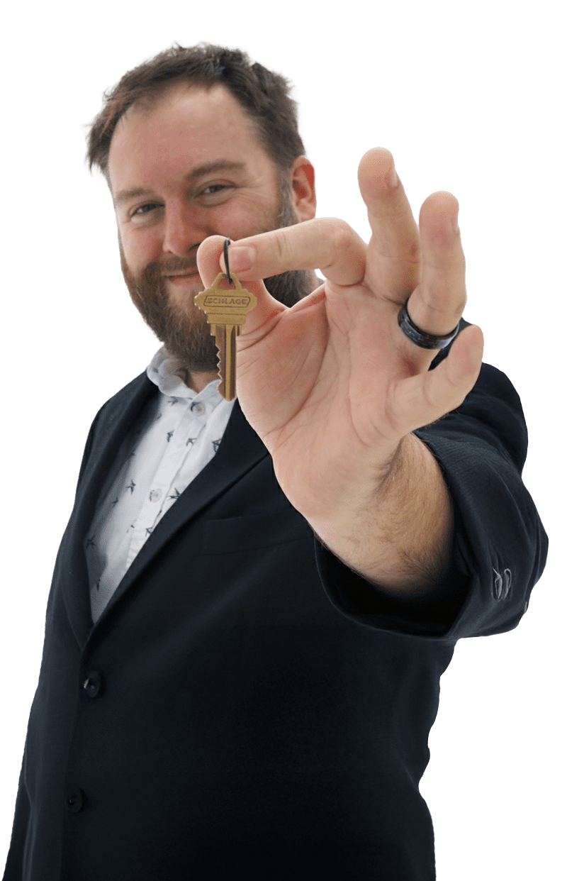 Realtor Patrick Brock holding out a house key