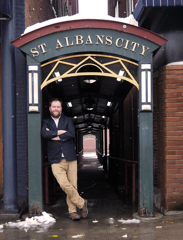 Patrick Brock standing under the walk way next to Twiggs on Main St in St Albans